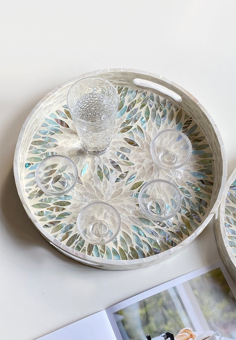 Round decorative tray with glass-like design on a light surface