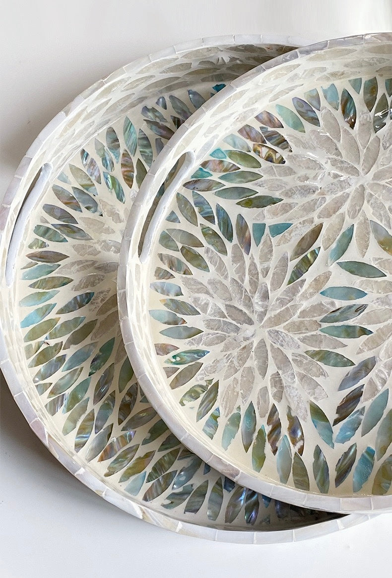 Set of three decorative coasters with floral pattern on a white background