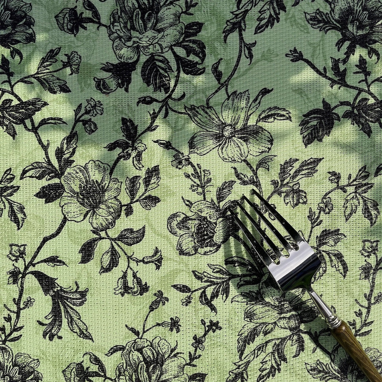Floral-patterned fabric with a wooden tool on top