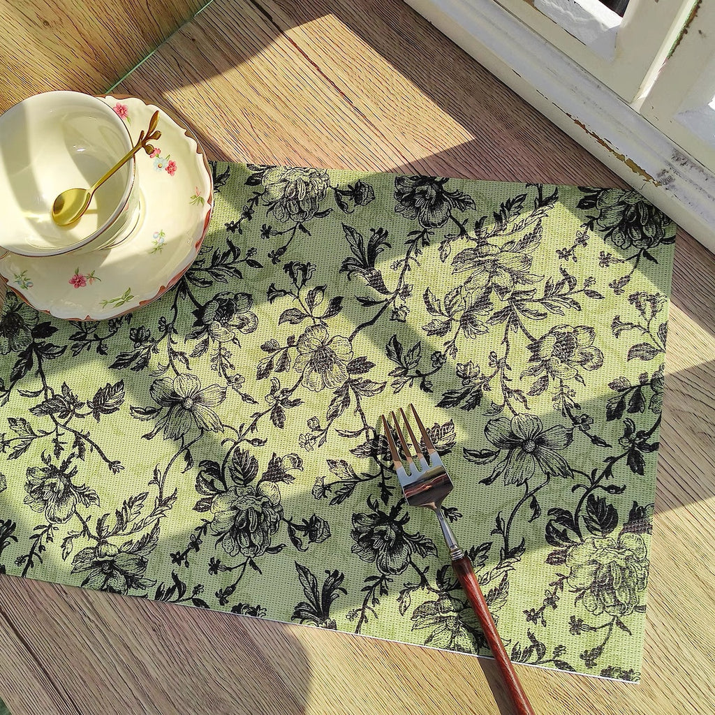 Floral patterned placemat with a fork on a wooden table